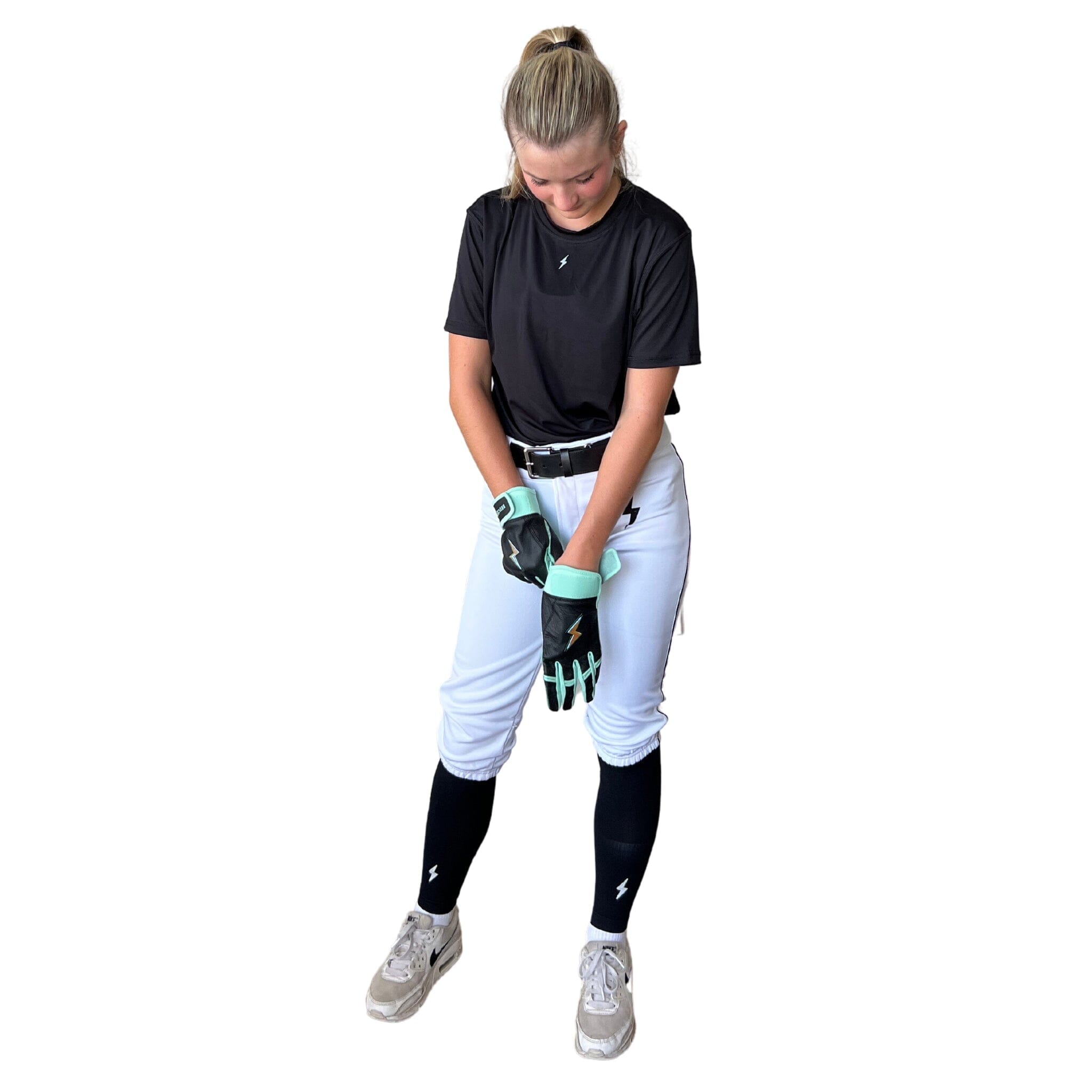Girl wearing batting gloves and white softball pants.