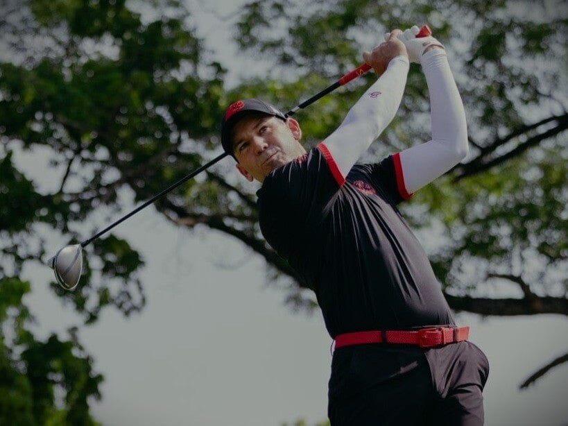 Golfer swinging a golf club.