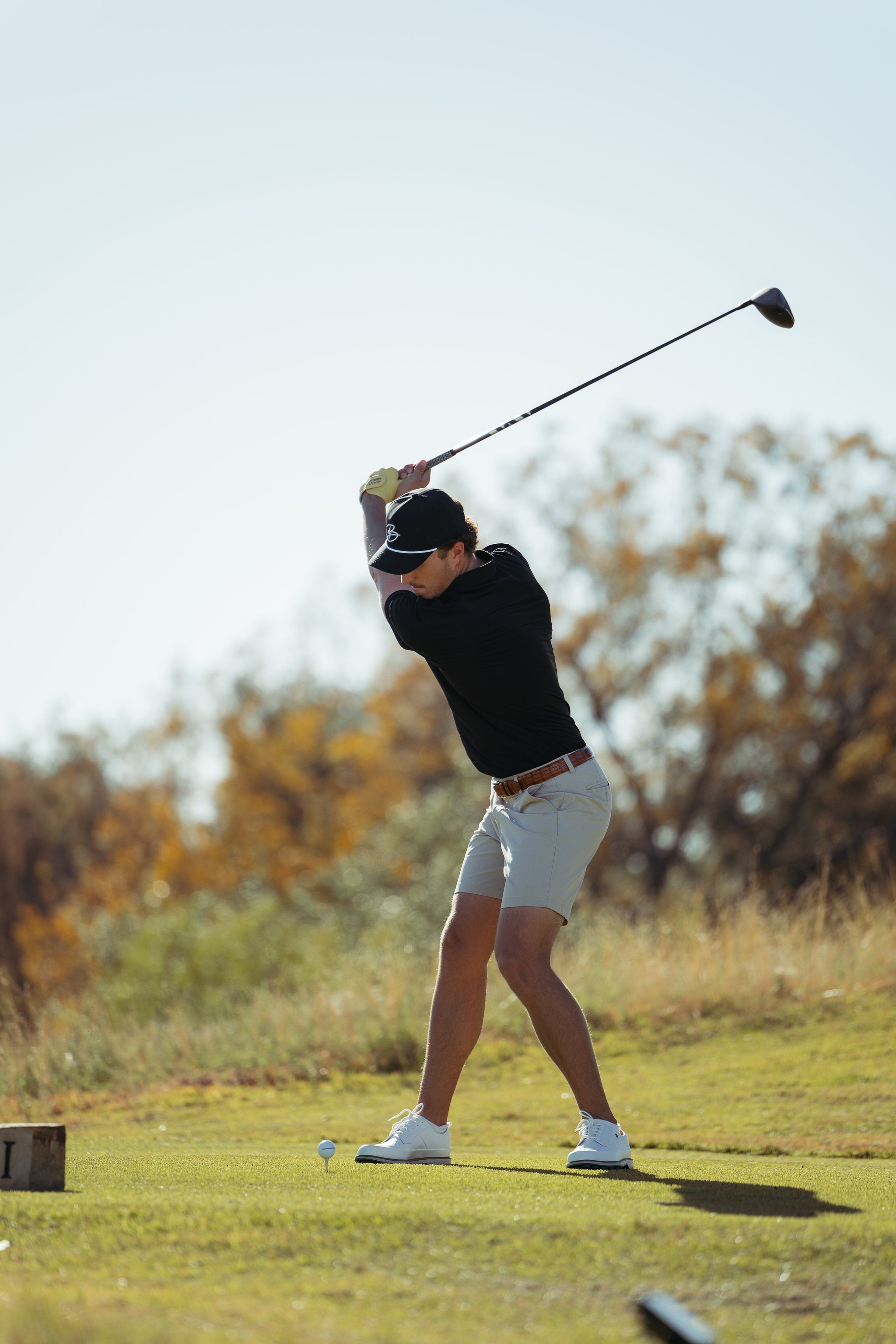 Golfer swinging a club.