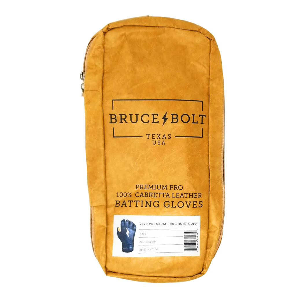 BRUCE BOLT Navy Short Cuff 2021 PREMIUM PRO GLOVE BAG. This is a batting glove bag made specifically for carrying BRUCE BOLT batting gloves.  The glove is kraft or tan color with black text and a black lightning bolt.  This bag has BRUCE BOLT Stickers and a Helmet Sticker inside. 