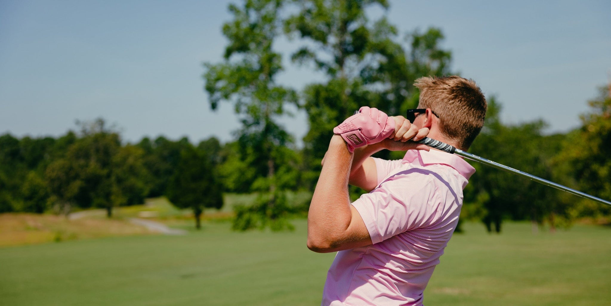 Image of golf player swinging a club.
