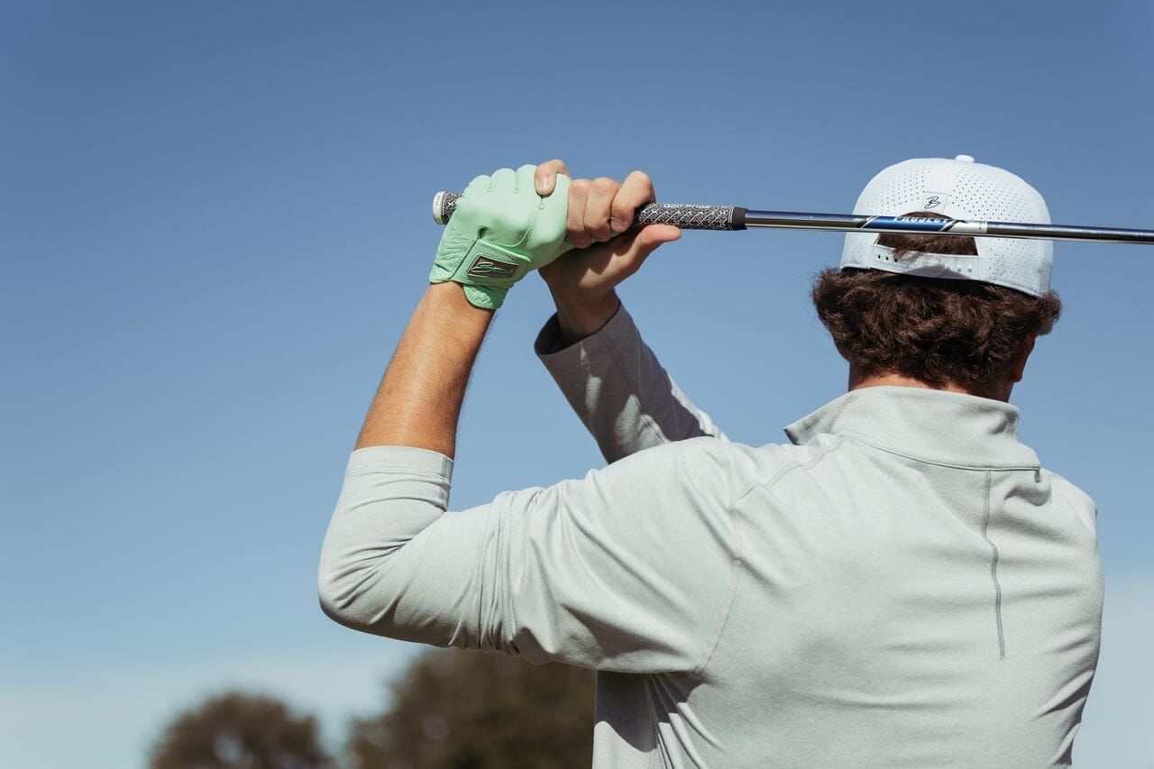 Image of golfer swinging golf club. 