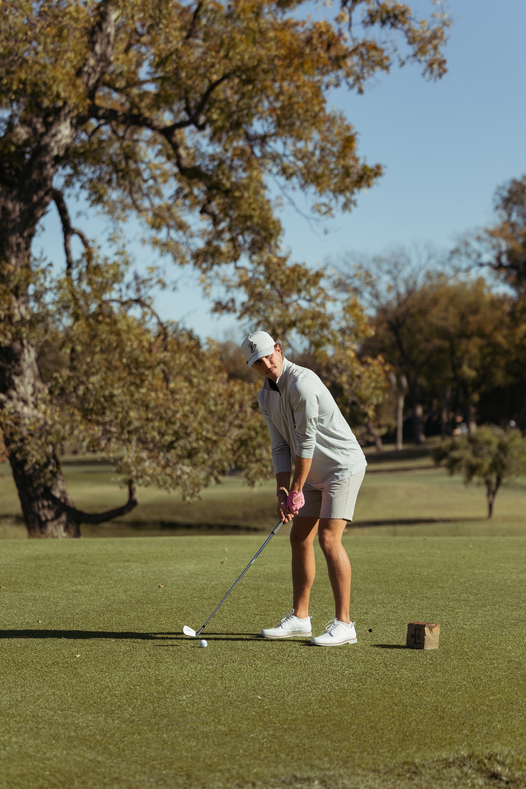 Golfer putting the ball. 