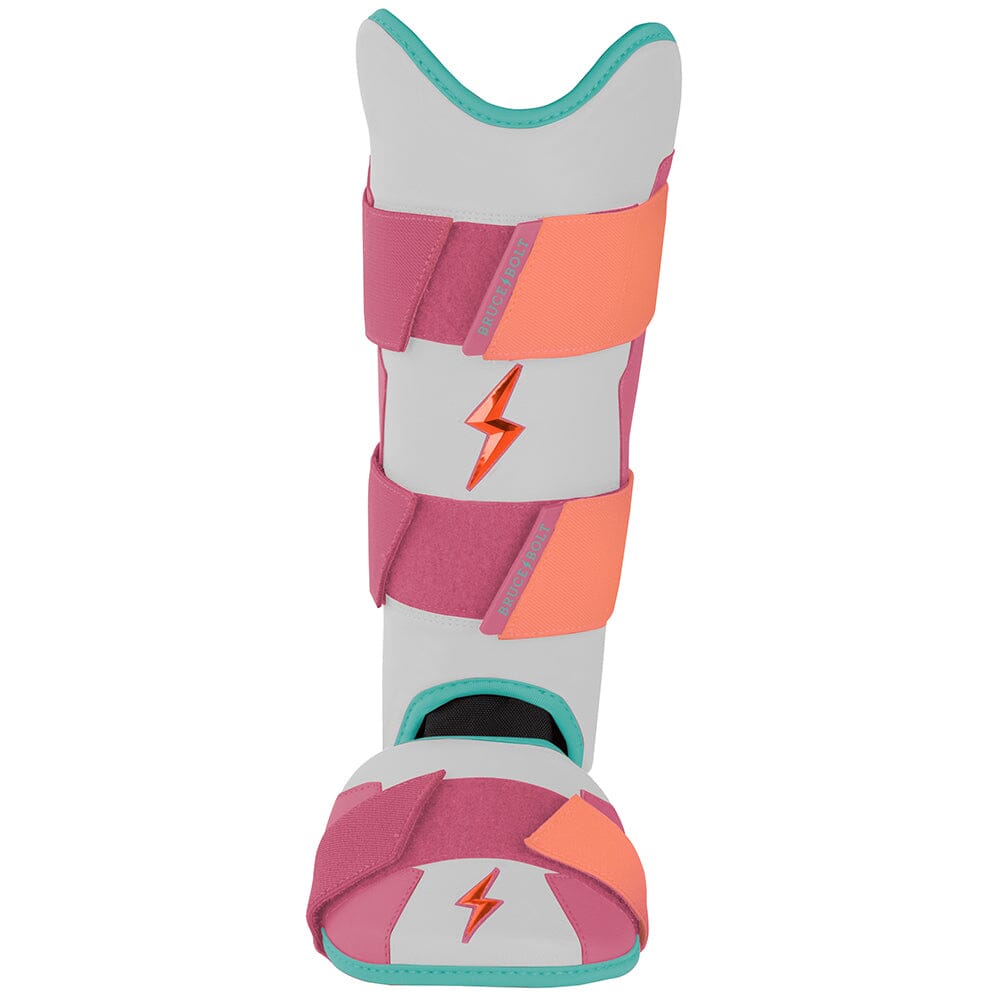 White and pink baseball leg guard with orange straps and teal trim, featuring an orange lightning bolt logo.
