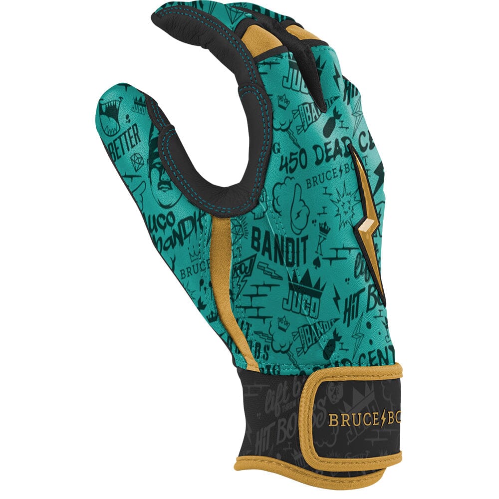 Mint green batting glove with black graffiti graphics, gold accents, and a black wrist strap with gold trim.
