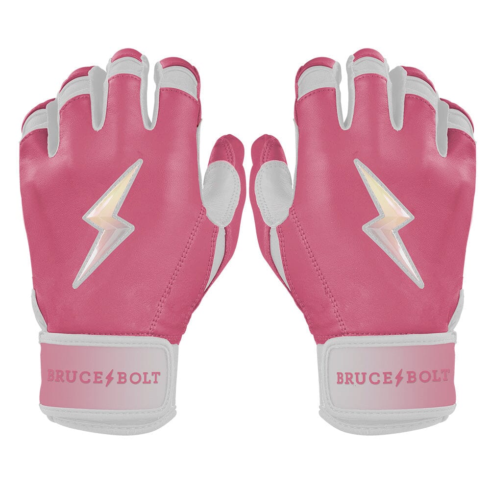 Pair of dusty pink and white short cuff batting gloves featuring a shiny lightning bolt logo and the Bruce Bolt brand name.