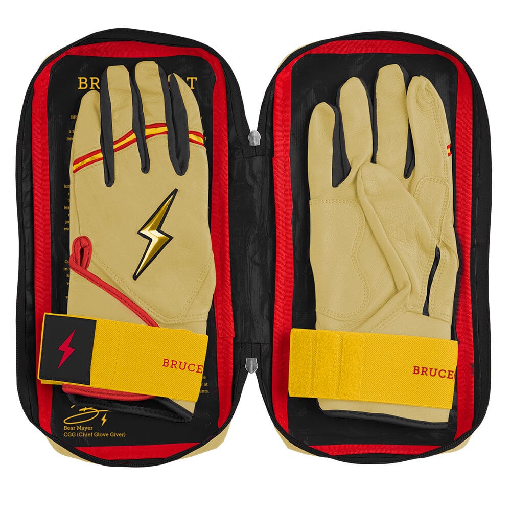Ivory and red batting gloves with gold lightning bolt logo inside an open case
